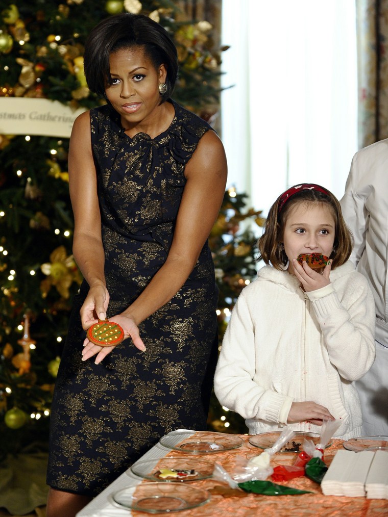 Image: US First Lady Michelle Obama shows a coo